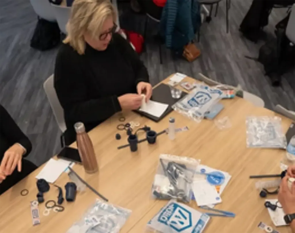a woman assembles a DROP Filter